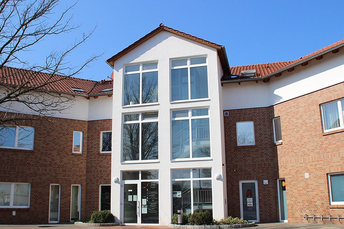 Das Ärztehaus in der Alten Heerstraße 22 in Wesendorf, ein zweigeschossiger Backsteinbau mit hellem Glasvorbau am Eingang